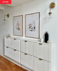 two framed pictures hang on the wall above a dresser in a white room with wood floors