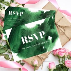 the rsvp card is on top of some pink roses