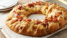 a bundt cake with bacon and cheese on it