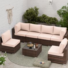 an outdoor living room with wicker furniture