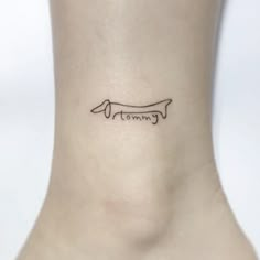 a small tattoo on the ankle of a woman's foot that reads, tomma