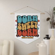 a sign that says dorm sheet dorm hangs on the wall next to a table and chairs