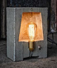 a light bulb sitting on top of a cement block