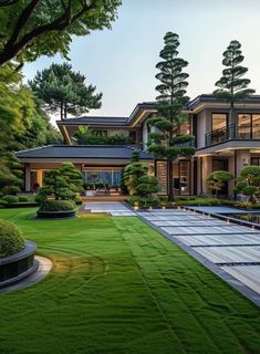 a large house with lots of trees and grass in front of the entrance to it