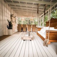 a porch with wooden floors and white walls