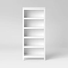 an empty white book shelf against a gray background