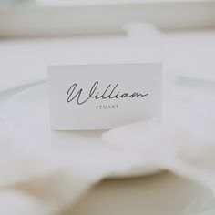 a place card sitting on top of a white plate