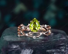 Ring details- Vintage pear cut green peridot bridal set, natural peridot vine wedding set, twig branch peridot engagement ring set, nature inspired floral ring,14k rose gold, 18k rose gold, 925 sterling silver twig branch leaf wedding promise ring gift for women, mom, best friend, girl and wife. Main Ring:  -Center stone: 1.3 CT 6x8mm pear shape natural peridot -Side stones: moissanite or diamond -Smooth tapered band. Wedding band: -Accent stone: moissanite or diamond -Band Width (Bottom): 1.6-1 Vine Wedding Ring, Peridot Engagement Ring, Peridot Engagement Rings, Twig Branch, Vine Wedding, Unique Roses, Peridot Jewelry, Wedding Promises, Promise Ring Gift