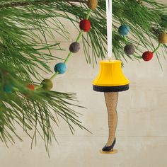 a christmas ornament hanging from a pine tree with stockings and stockings on it