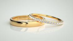 two gold wedding rings with diamonds on white background