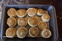 a pan filled with cinnamon rolls on top of a table