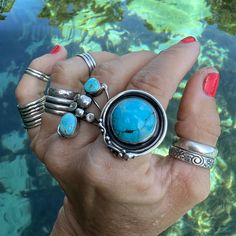 "BLUE TURQOISE RING ---- Handcrafted and set in oxidized STERLING SILVER --- Boho Chic Style ROUND SHAPED STONE --- US Women's Size 7.75 SPRING WATER BLUE ARTISAN MADE BABY BLUE COLORED TURQUOISE STATEMENT RING -- A unique and one-of-a-kind turquoise ring that has been framed in a freeform setting of handcrafted oxidized sterling silver that is typical of the jewelry artist. This piece of wearable art jewelry has been signed and dated by the jewelry artist ~ 2022. SIZE 7.75 (7 3/4) | SOLID Style Blue Oxidized Finish Jewelry, Artisan Blue Jewelry With Oxidized Finish, Blue Hand Forged Rings As Gift, Blue Sterling Silver Fusion Rings, Fusion Style Blue Sterling Silver Rings, Unique Blue Open Ring, Blue Fusion Style Round Rings, Bohemian Hand Forged Turquoise Ring, Bohemian Blue Handmade Stackable Rings