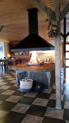 a kitchen with a large stone counter top and an open fire place in the center