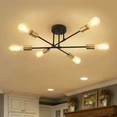 an image of a kitchen light fixture in the middle of the room with white cabinets