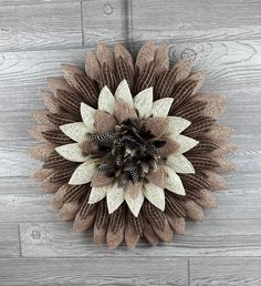 a brown and white flower on a wooden wall