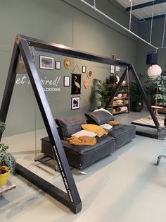 a living room filled with furniture and lots of plants