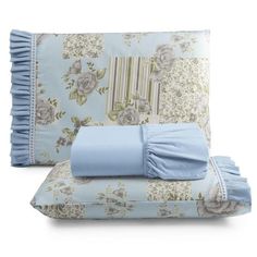 a bed with blue sheets and pillows on top of it next to a pillow case