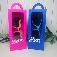 two blue and pink boxes with barbie sunglasses in them