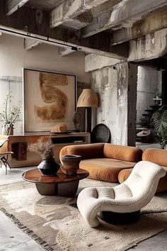 a living room filled with furniture next to a painting on the wall in an old building