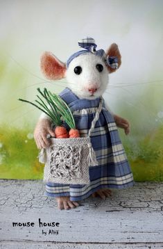 a stuffed mouse is holding a basket with carrots