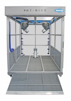 the inside of a metal container with blue hoses attached to it's sides