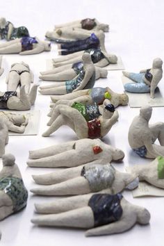 many small ceramic figurines are laying on the ground