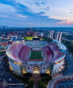 an aerial view of the football stadium in atlanta, with its lights on at dusk