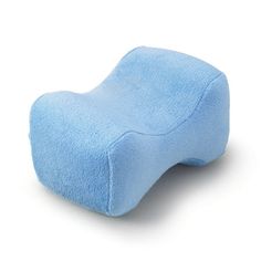 a blue pillow sitting on top of a white surface