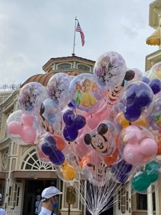 a bunch of balloons that are in the shape of mickey mouse and other disney characters