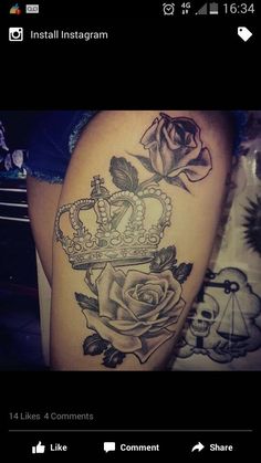 a woman's thigh with a crown and rose tattoo on it