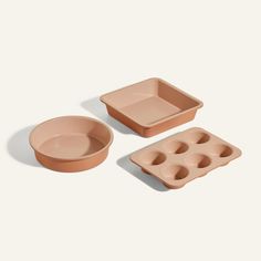 three pieces of pink plastic food trays, one with an egg pan and the other with