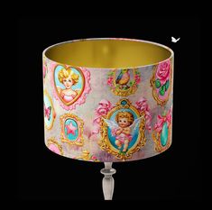 a lamp shade with an image of a baby angel on it's pink and gold background