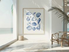 a chair sitting next to a window near a palm tree and sea shells on the wall