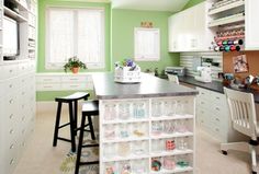 a kitchen filled with lots of white cabinets and counter top space next to a window