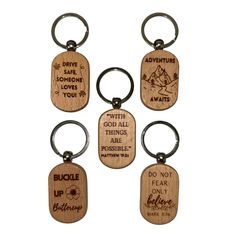 six wooden keychains with different sayings on them, including one that says adventure is