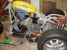 an image of a motorcycle being worked on in a garage with tools and other equipment