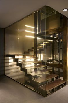 the stairs are made of glass and wood with light shining through them in this modern building