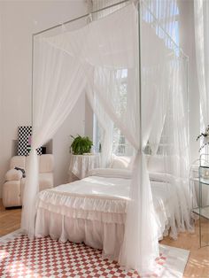 a white bed sitting in a bedroom on top of a checkered floor