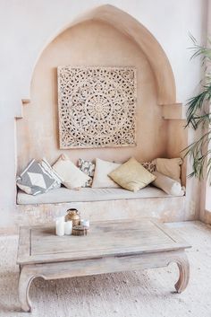 a living room with a couch, coffee table and potted plant