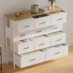 a white dresser with drawers on top of it