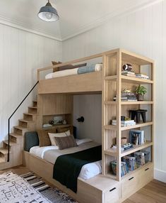 an instagramted photo of a bunk bed with bookshelves and stairs on it