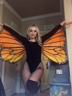 a woman in a black bodysuit and butterfly wings