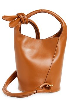 A knotted shoulder strap wraps the rounded bucket silhouette of this calfskin style that joins the label's collection of innovative handbags. Snap closure Top carry handle; shoulder strap Interior zip pocket Structured silhouette with flat base and protective metal feet Leather Made in Italy Designer Handbags Bag Light, Leather Bucket Bag, Leather Bucket, Snap Closure, Light Brown, Top Handle, Calf Skin, Bucket Bag, Zip Pockets