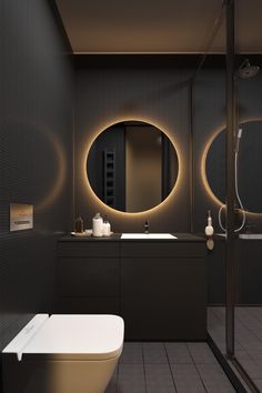 a bathroom with a toilet, sink and mirror