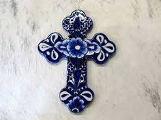 an ornate blue and white cross on a marble surface