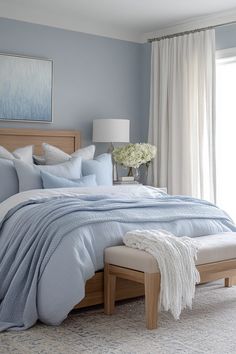 a bedroom with blue walls and white curtains