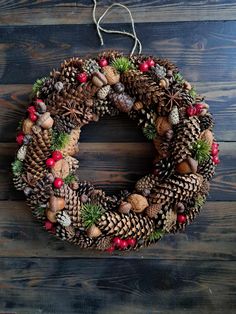 a pine cone wreath hanging on a wooden wall