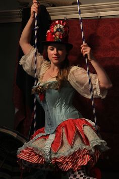 a woman in a costume is sitting on a swing