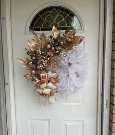 a white door with a wreath on it