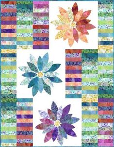 a colorful quilt with flowers on it and stripes in the background that are multicolored